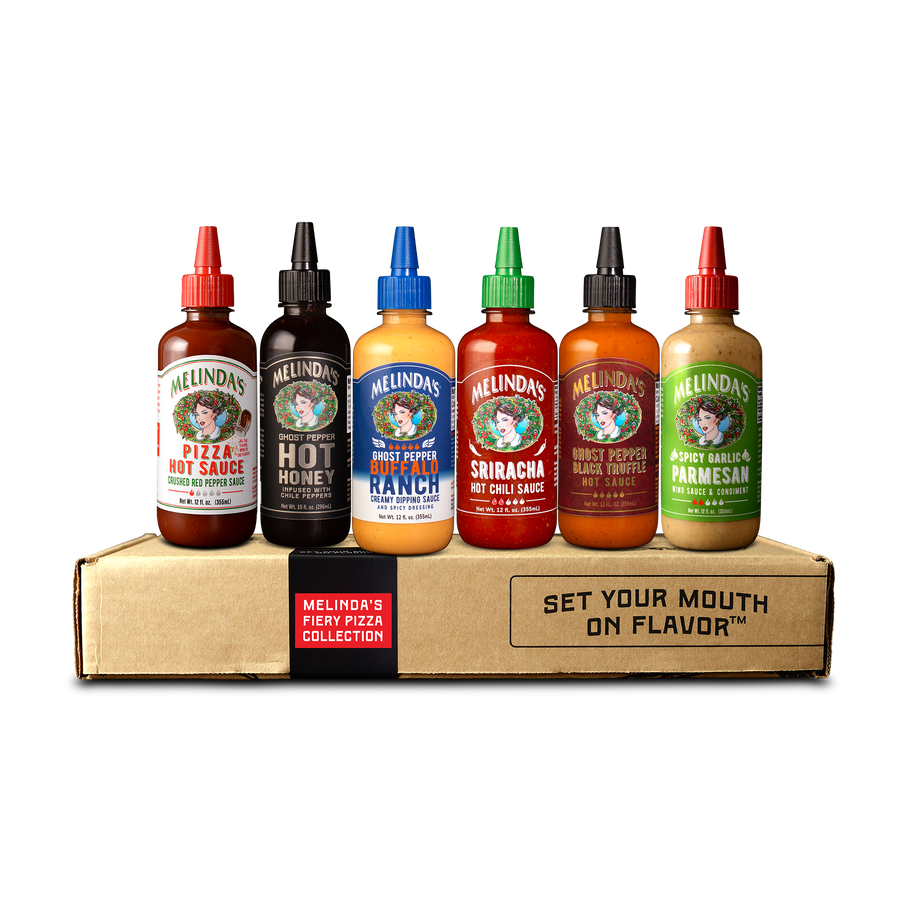 A group of bottles of Melinda's Fiery Pizza Collection hot sauces, including Pizza Hot Sauce, Ghost Pepper Hot Honey, Ghost Pepper Buffalo Ranch, Sriracha Hot Chili Sauce, Ghost Pepper Black Truffle Hot Sauce, and Spicy Garlic Parmesan.