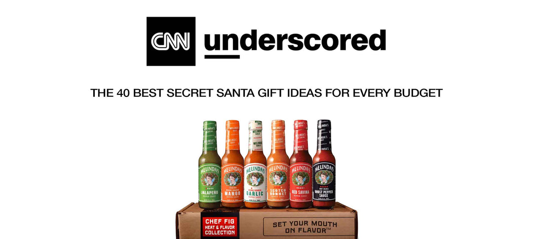 Six bottles of Melinda's hot sauce in different flavors arranged on a wooden gift box for Secret Santa gift ideas