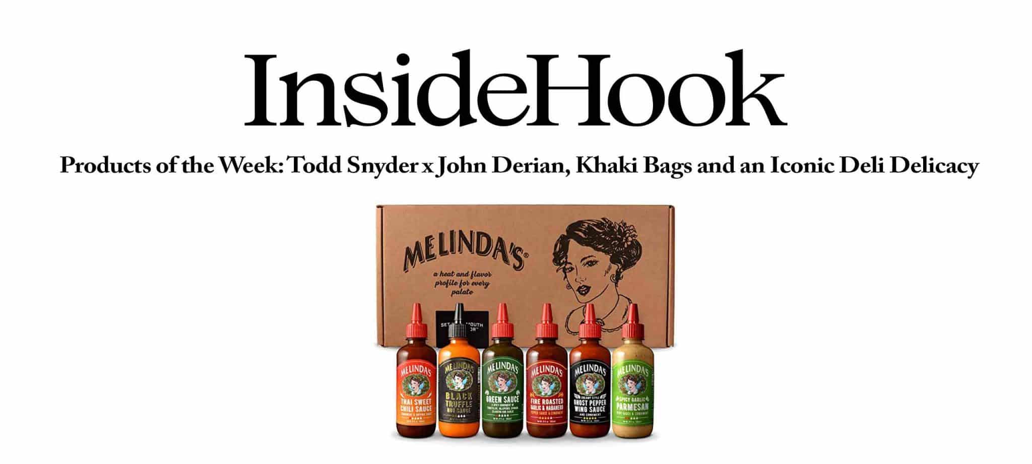 Melinda's hot sauce collection featuring six different flavored bottles displayed in front of branded cardboard packaging