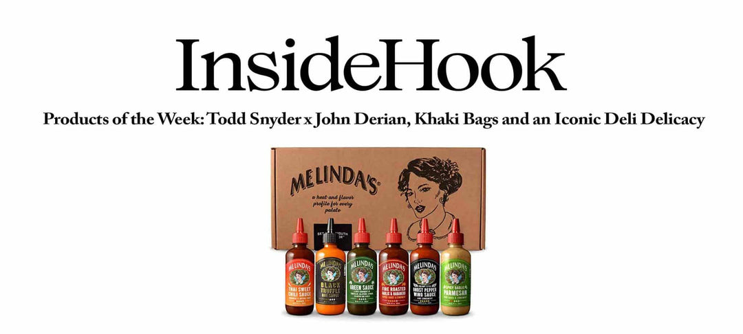 Melinda's hot sauce collection featuring six different flavored bottles displayed in front of branded cardboard packaging