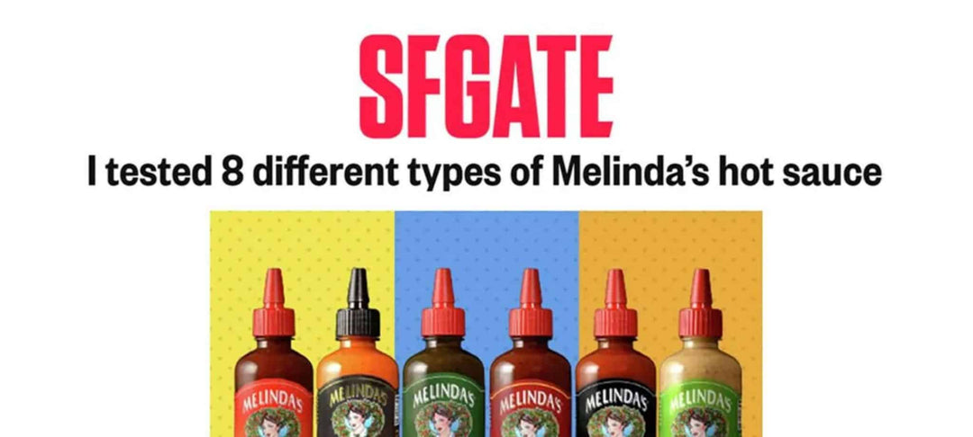 Six bottles of Melinda's hot sauce with different colored labels arranged in a row against colorful background