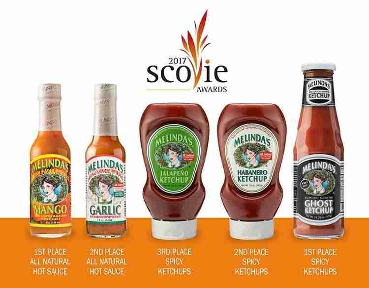 Five Melinda's sauce bottles displaying 2017 Scovie Awards placements: Mango and Ghost Ketchup won 1st place, Garlic and...