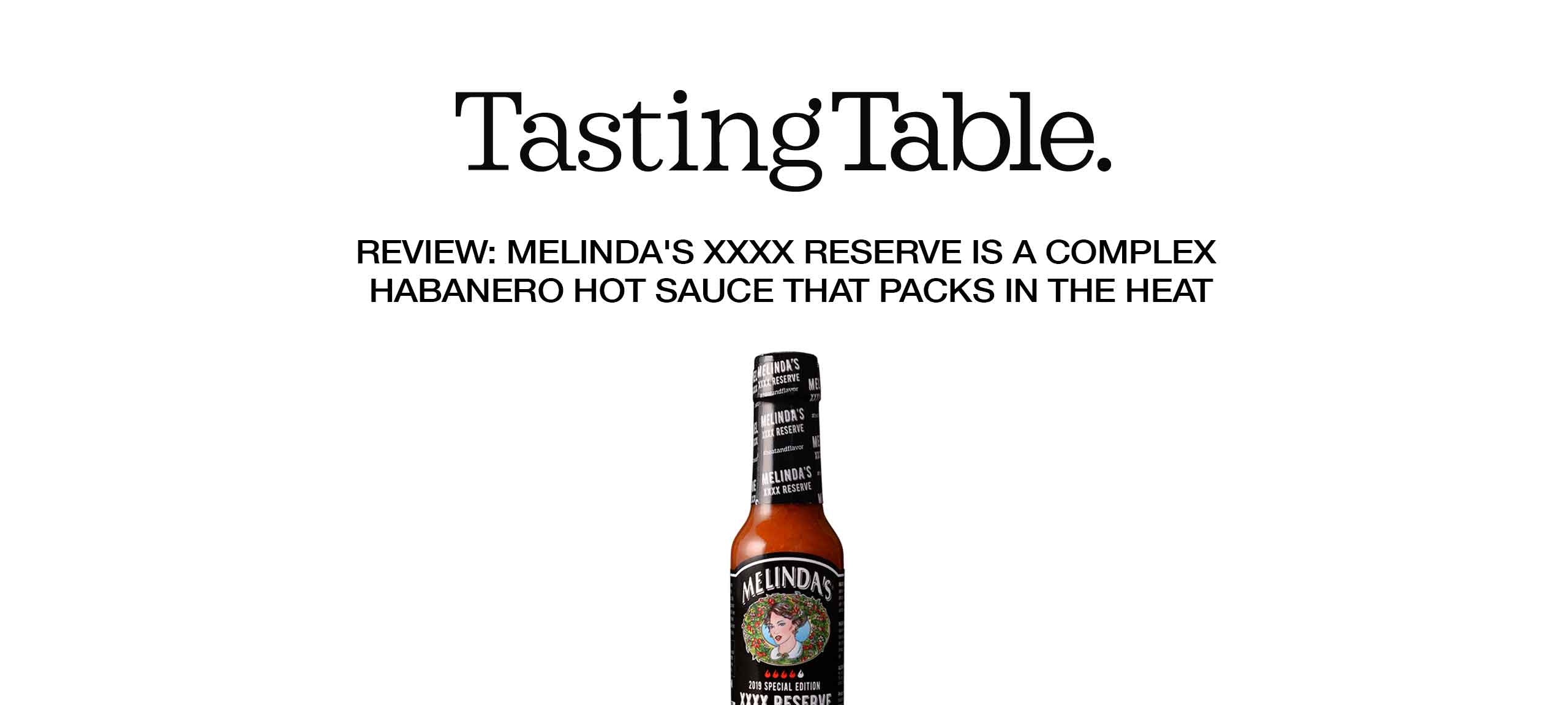 Melinda's XXXX Reserve habanero hot sauce bottle with black label featuring colorful woman's portrait illustration
