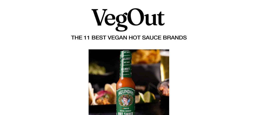 Melinda's hot sauce bottle with green label featuring woman's portrait, surrounded by blurred food in background