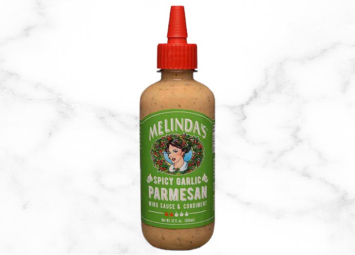 Melinda's Spicy Garlic Parmesan wing sauce and condiment in squeeze bottle with green label and red cap