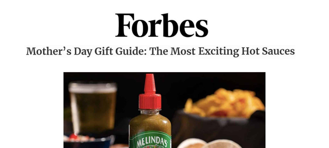 Forbes logo above Mother's Day hot sauce gift guide headline, with bottle of Melinda's hot sauce, beer, and chips displayed