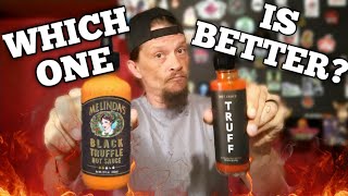 Man holds two bottles of hot sauce with "WHICH ONE IS BETTER?" text overlay, comparing sauces for review