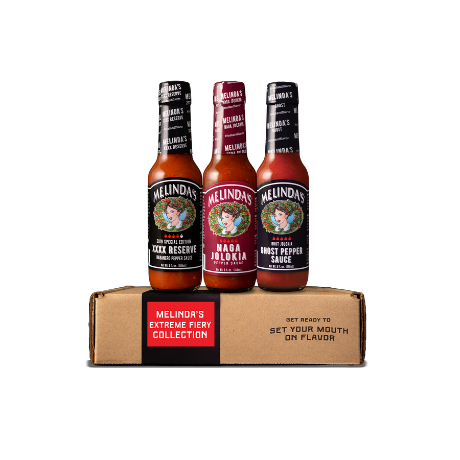 Melinda's Extreme Fiery Collection gift box with three 5 oz bottles: XXXX Reserve habanero pepper sauce, Naga Jolokia pepper sauce, and Ghost Pepper sauce
