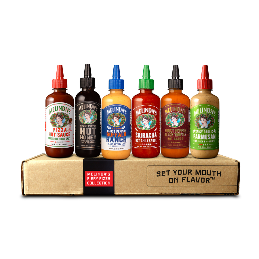 A group of bottles of Melinda's Fiery Pizza Collection hot sauces, including Pizza Hot Sauce, Ghost Pepper Hot Honey, Ghost Pepper Buffalo Ranch, Sriracha Hot Chili Sauce, Ghost Pepper Black Truffle Hot Sauce, and Spicy Garlic Parmesan. 