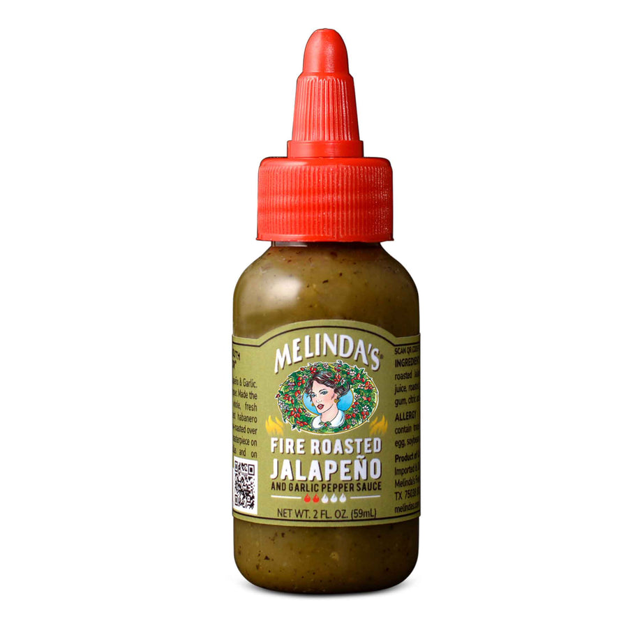 A close-up of Melinda's Fire Roasted Jalapeño & Garlic Pepper Sauce Mini-Squeeze bottle.
