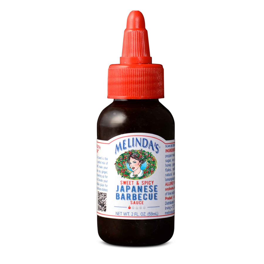 A bottle of Melinda's Sweet & Spicy Japanese Barbecue sauce, perfect for glazing wings, ribs, and roasts. Soy, ginger, garlic, red chilies, and honey create an umami explosion. Elevate your meals with this delectable 2oz Mini-Squeeze.