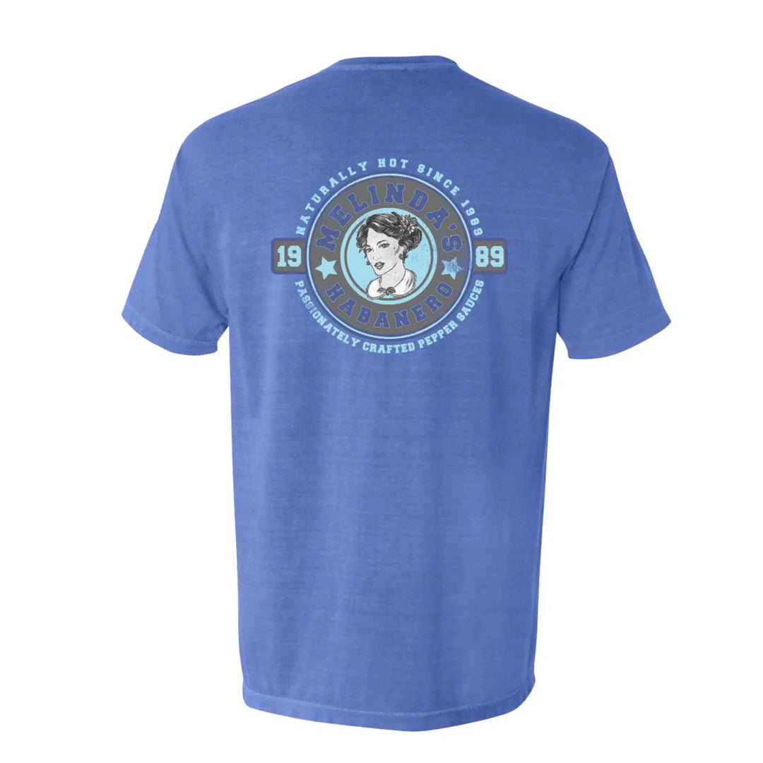 A Flo Blue Comfort Colors Pocket Tee with an image of a woman in a blue dress by Melinda's Sauce.